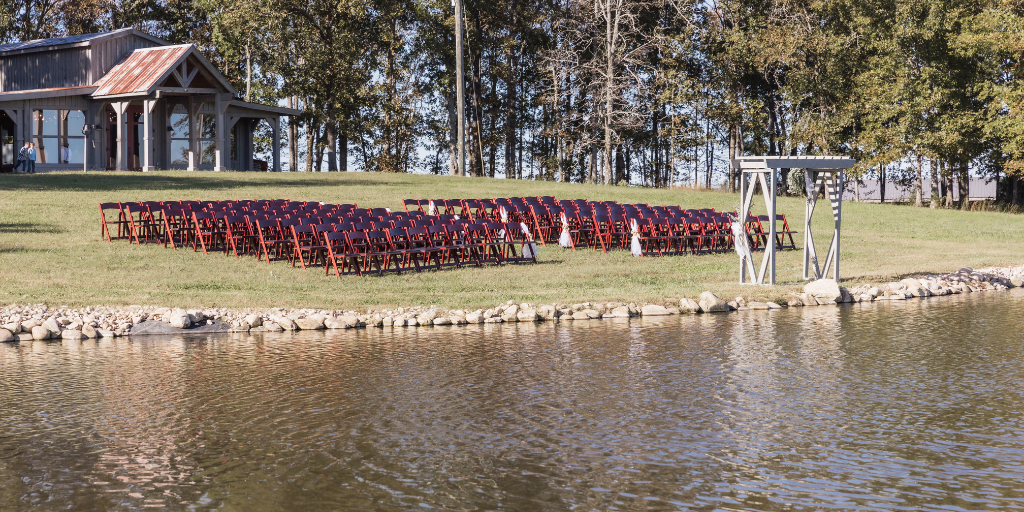 Wedding ceremony chairs set up by the pond with the fountain in the middle